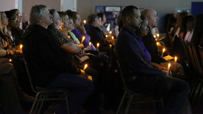 Attendees watch a video tribute to victims during the Delaware Victims' Rights Task Force 25th Annual Crime Victims Tribute at Delaware State University in Dover Wednesday.