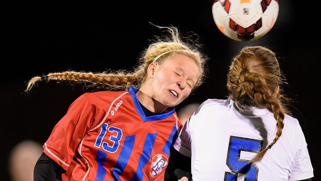 St. Cloud Apollo's Jessica Timpane, left, heads the ball past Sartell's Megan Sieben during the first half Thursday in the Section 8A girls soccer championship at Husky Field.