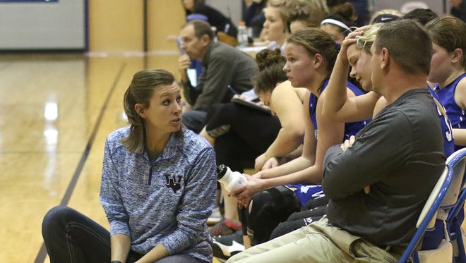 Windthorst head girls basketball coach Heather Stark talks to Tatum Veitenheimer on the sideline during the game against Springtown in the Windthorst Tournament Tuesday, Dec. 27, 2016, in Windthorst.