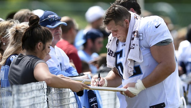 Titans center Brian Schwenke (62) signs autographs for fans after practice at St. Thomas Sports Park Thursday Aug. 4, 2016, in Nashville, Tenn.