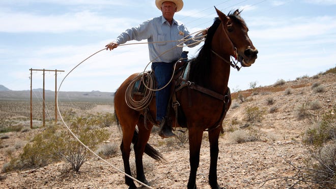 Rancher Cliven Bundy pulls in a rope while on horseback at a protest area near Bunkerville, Nev. Wednesday, April 16, 2014. (AP Photo/Las Vegas Review-Journal, John Locher)