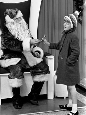 Five year old Kathy Diviney receives a sucker after