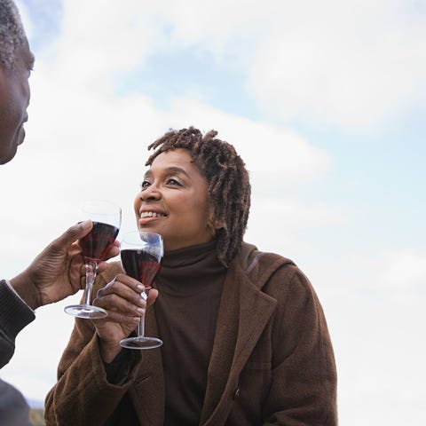Older couple drinking wine together outside