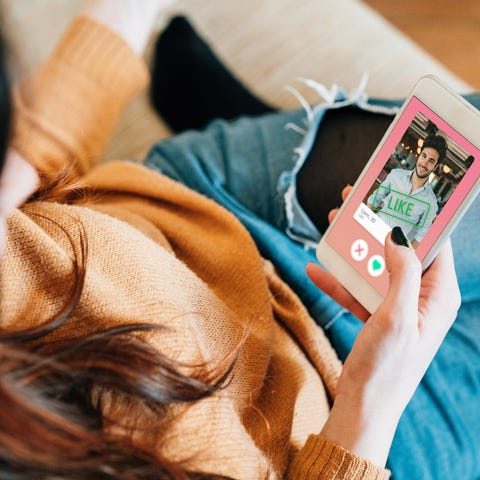 A woman looks at a man's picture on a dating app.