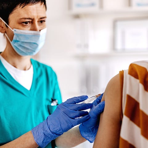 Healthcare professional giving a vaccine shot to a