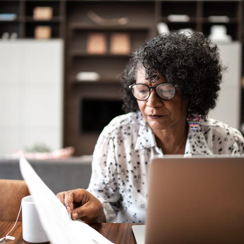 Adult looking at financial paperwork.