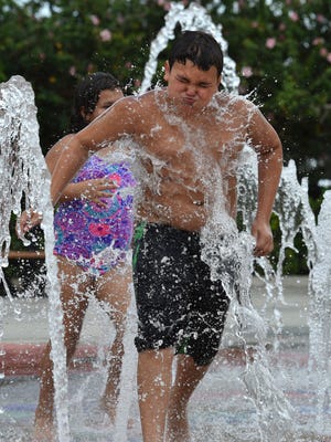 "All the water, it’s splashing, the heat is good for this," said Gerard Constantine, 11, of Vero Beach after sprinting through cool jets of water while chased by his sister Jayde, 9, as the pair try to stay cool playing in the Royal Palm Pointe Park fountains on Friday, July 20, 2018, in Vero Beach. "It's fun, because there is lots of water and it's good for a nice hot day, and you have fun with other kids and get to splash around," Jayde said. At 2:30 p.m. the temperature in Vero Beach rose to 95 degrees, with a heat index of 103, according to the National Weather Service. "I hate it, it's too hot, unless you are in the water, it's too hot," said Lisa Constantine, Gerard and Jayde's mother. "It gets them out of the house for a while, and a great place to come during summer break."
