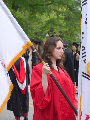 Junior Marshall Emma Rehfeld marches with the flag at the Bard College 157th Commencement May 27, 2017, at the college in Annandale-on-Hudson.