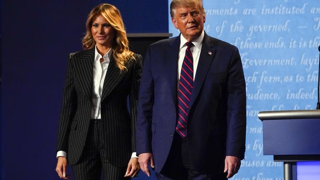 President Donald Trump stands on stage with first lady Melania Trump after the first presidential debate with Democratic presidential candidate former Vice President Joe Biden on Tuesday night at Case Western University and Cleveland Clinic, in Cleveland, Ohio.