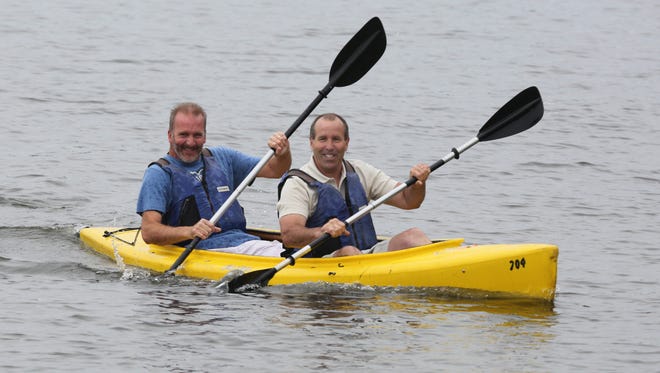 Supervisor Geoff Finn and Councilman Jim Monaghan from the Town of Stony Point, in the lead kayak, power their way toward first place during the Rockland Supervisor's Challenge at Lake DeForest Day in Clarkstown, June 27, 2015.  The event hosted by United Water, with Orange and Rockland, was a fundraiser for the Hackensack Riverkeeper. This was the inaugural event for members of the community to enjoy the lake with a kayak or canoe ride. 