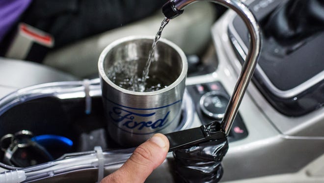 Ford’s prototype On-the-Go H2O system collects, filters and pumps water directly to a faucet hanging over the cupholders.