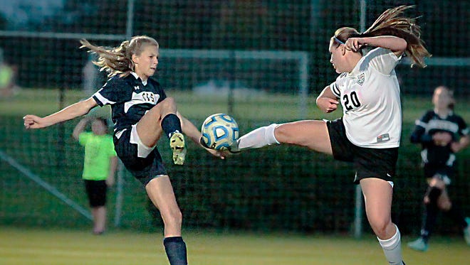 Central Magnet's Alex Shea (20) goes up for a ball against Chattanooga Christian's Sofie James during CCS' 1-0 win over Central.