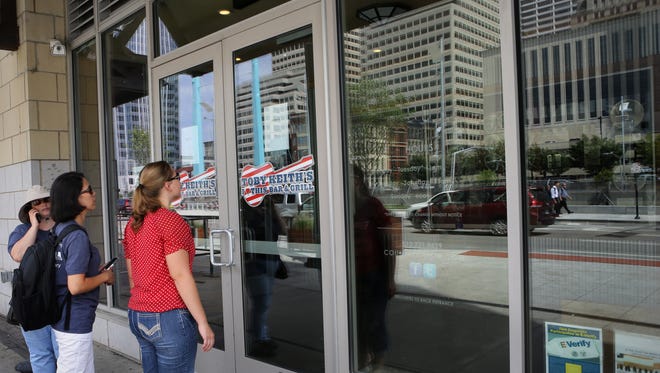 After Toby Keith's I Love This Bar & Grill at The Banks closed its doors, passers-by read signs that say: 'This premises is closed. For leasing inquiries, please contact 513.366.3550. Thank you.'