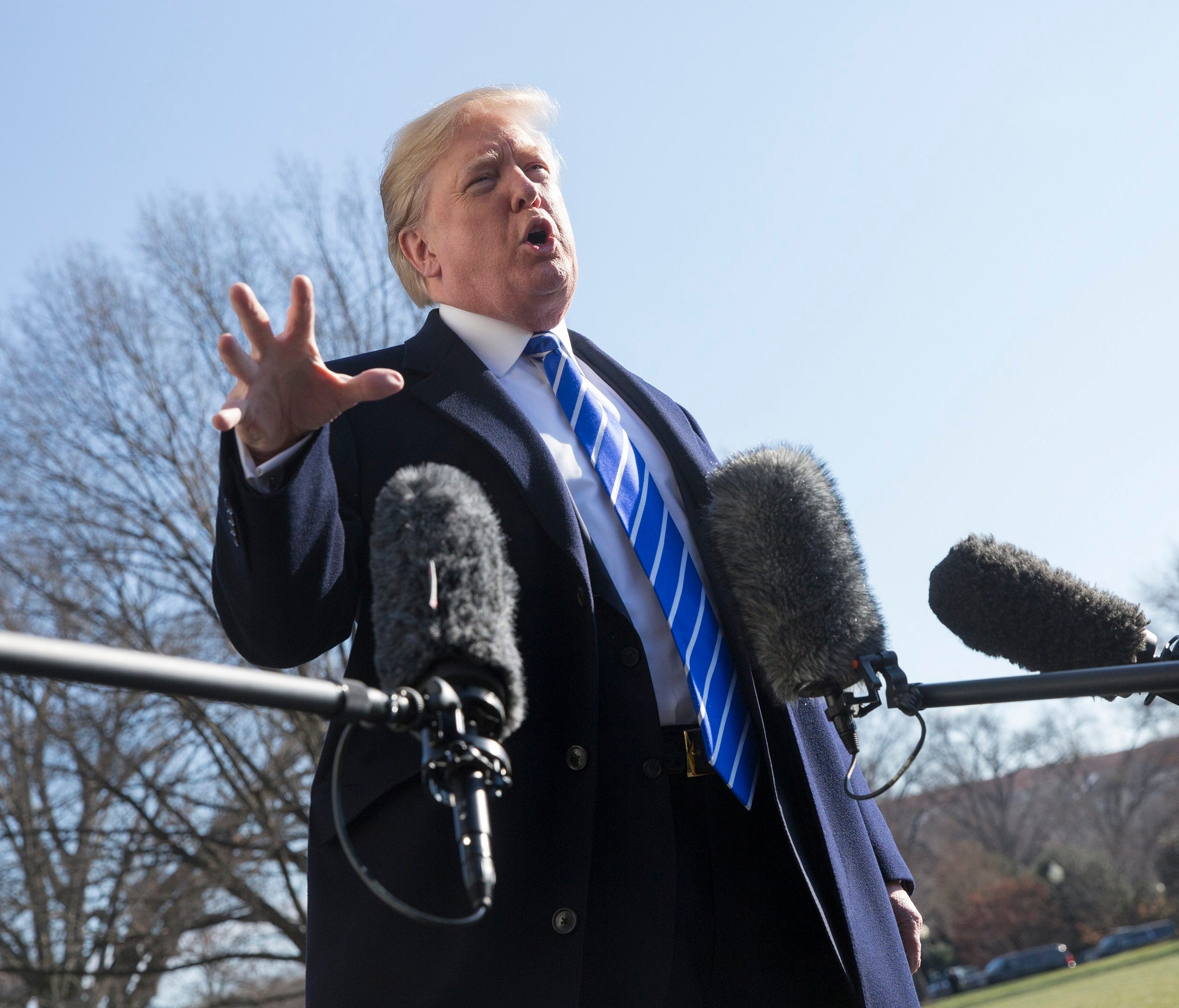 President Trump is pictured  speaking to reporters as he departs the White House.
