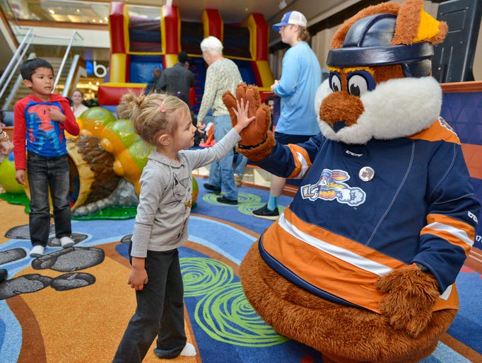 The Greenville Swamp Rabbits mascot, Stomper, plays