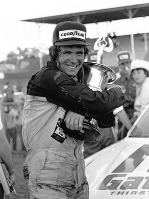 Darrell Waltrip hugs his trophy in the Victory Lane