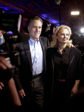 Mitt Romney and his wife Ann are surrounded by media after he addressed the RNC.