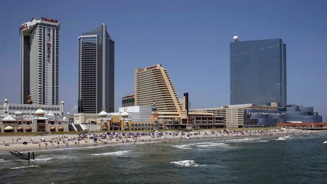 In this July 23, 2014, file photograph, the closed casinos, Revel Casino Hotel, right, stands along the Boardwalk near Trump Taj Mahal Casino, left, with its Chairman Tower, and the Showboat Casino Hotel, second right, in Atlantic City. The troubled gambling resort saw the Trump Taj Mahal casino close, putting a final end to Trump’s legacy in Atlantic City.