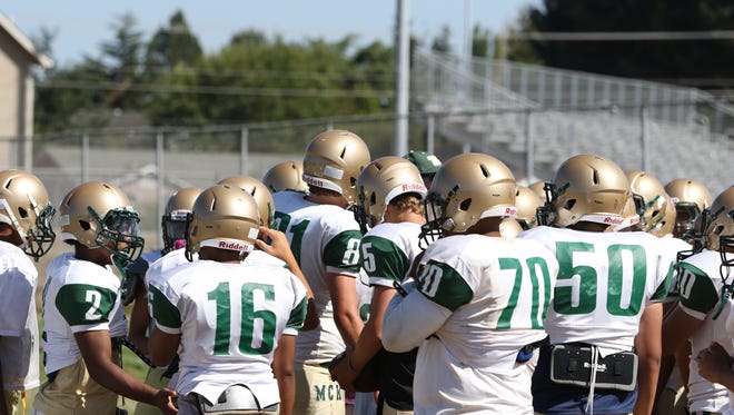 Players participate in practice on Friday, Aug. 21, 2015, at McKay High School in Salem.