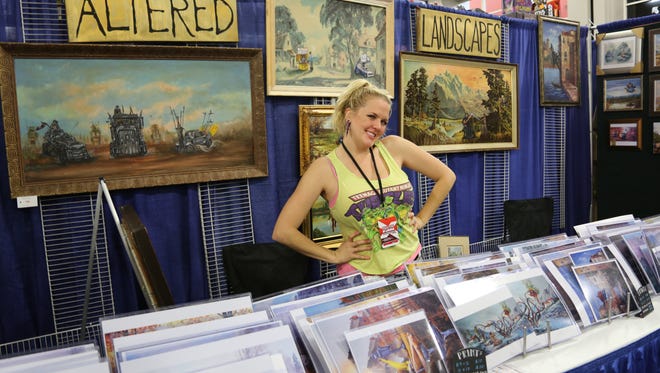 Kat Martin poses with her art at the 3rd annual Salt Lake Comic Con Fan Xperience Friday, March 25, 2016. 