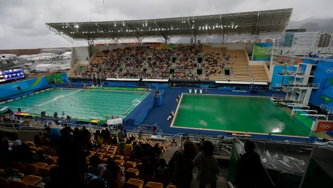 The water of the Olympic diving pool at right in Rio appears a murky green as the water polo pool at left appears a lighter greener color.