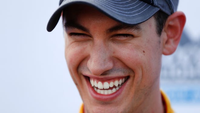 Joey Logano smiles after winning the pole in qualifications for the NASCAR Sprint Cup Series auto race at Michigan International Speedway, in Brooklyn, Mich., Friday, Aug. 26, 2016.