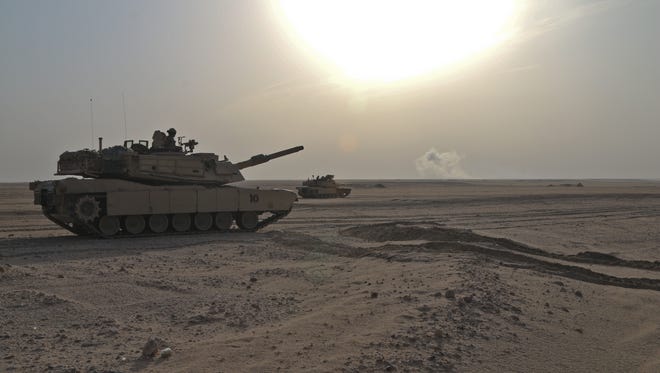 Abrams tanks move to engage targets during a joint combined arms live-fire exercise near Camp Buehring in Kuwait on Dec. 6-7. The exercise tested the ability of the U.S. Army and the Kuwaiti army and air force in their ability to identify and eliminate enemies' anti-aircraft capabilities.