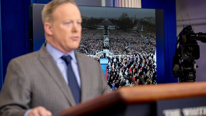 An image of the inauguration of President Donald Trump is displayed behind White House press secretary Sean Spicer as he speaks at the White House, Saturday, Jan. 21, 2017, in Washington.  (AP Photo/Andrew Harnik)