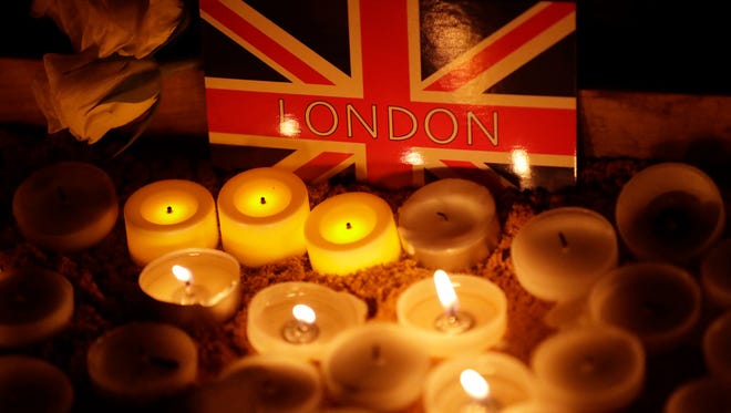 People light candles at a vigil for the victims of Wednesday's attack, at Trafalgar Square in London, Thursday, March 23, 2017. The Islamic State group has claimed responsibility for an attack by a man who plowed an SUV into pedestrians and then stabbed a police officer to death on the grounds of Britain's Parliament. Mayor Sadiq Khan called for Londoners to attend a candlelit vigil at Trafalgar Square on Thursday evening in solidarity with the victims and their families and to show that London remains united. (AP Photo/Matt Dunham)