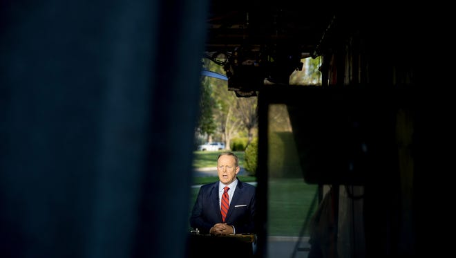White House press secretary Sean Spicer speaks on cable news on the North Lawn of the White House, Tuesday, April 11, 2017, in Washington. Spicer is apologizing for making an "insensitive" reference to the Holocaust in earlier comments about Syrian President Bashar Assad's use of chemical weapons. (AP Photo/Andrew Harnik)