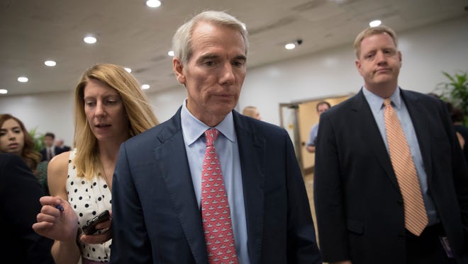 FILE- In this July 20, 2017, file photo, Sen. Rob Portman, R-Ohio, heads to the chamber for a vote, on Capitol Hill in Washington. President Donald Trump is scheduled to visit Ohio on Tuesday, July 25, as the U.S. Senate could vote on beginning debate on a Republican health care bill. Portman could be a key swing vote on the legislation and is facing immense pressure from both sides as he makes his decision. (AP Photo/J. Scott Applewhite, File)