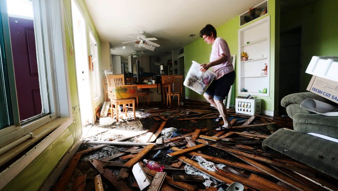 Jeanne Blaney, a resident of Shady River Lane off of the Orange River in Buckingham, Florida removes personal items after her home was flooded from water associated with Hurricane Irma. She and her family rode out the storm in the home and had to evacuate as flood waters rose around them as the storm passed by. Many homes along the road were flooded in storm.  