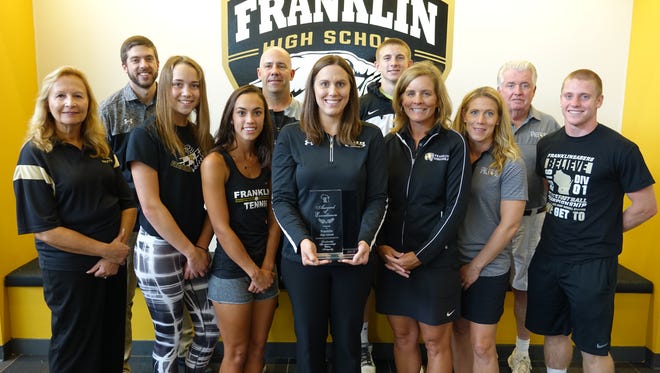 Student-athletes and coaches pose for a photo with the award the school received from the WIAA. 
Back (from left): Coach Eric Brandenburg, Coach Louis Brown, Ryley Clark, Coach Jim Hughes.
Front: Coach Gail Champion, Mackenzie Bollis, Morgan Edwards, Athletic and Activies Director Sara Unertl, Coach Brandy Johnston, Coach Katie Moore, Brad Tobin.