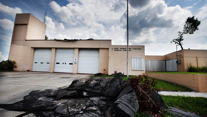 Roofing debris from Lehigh Acres Fire Control District Station 101 sits in front of the structure on Joel Boulevard at 10th Street in Lehigh Acres on Wednesday 9/27/2017. The station was damaged in Hurricane Irma and is temporarily closed. Fire crews were moved to other stations nearby. By the middle of October, temporary living arrangments for crews should be available.  