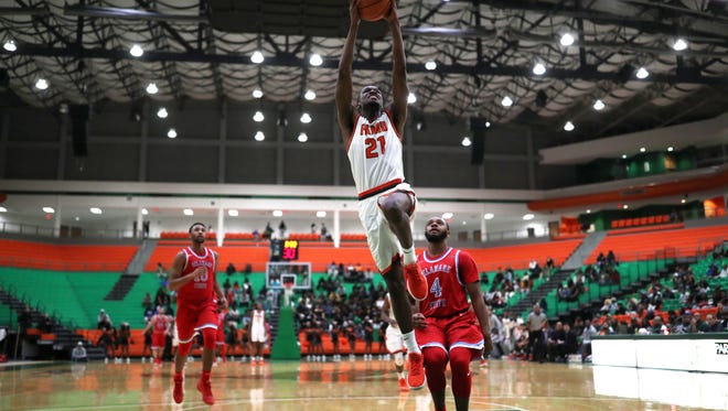 FAMU's Justin Ravenel dunks the ball on a fast break against Delaware State at the Al Lawson Center on Monday, Jan. 15, 2018. 