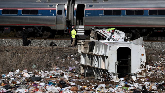 Emergency personnel work at the scene of a train crash involving a garbage truck in Crozet, Va., on Wednesday, Jan. 31, 2018. An Amtrak passenger train carrying dozens of GOP lawmakers to a Republican retreat in West Virginia struck a garbage truck south of Charlottesville, Va. (Zack Wajsgrasu/The Daily Progress via AP)