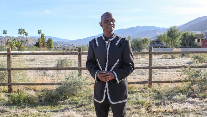 Alvin Taylor stands near an empty parcel of land on Tahquitz Canyon Road in Palm Springs, where his boyhood home was burned down  in the 1960s along with other homes in the area known as Section 14.