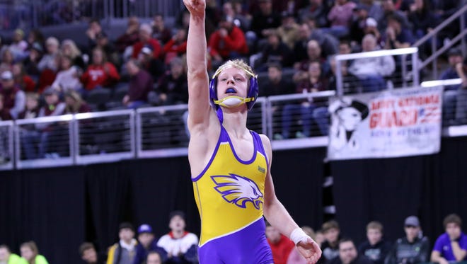 Kellyn March of Canton acknowledges the crowd after winning the Class B 126 title against Wyatt Turnquist of Winner on Saturday in Sioux Falls.