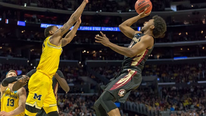 FSU guard Terance Mann makes the first basket of the Noles' Elite 8 match-up with Michigan.