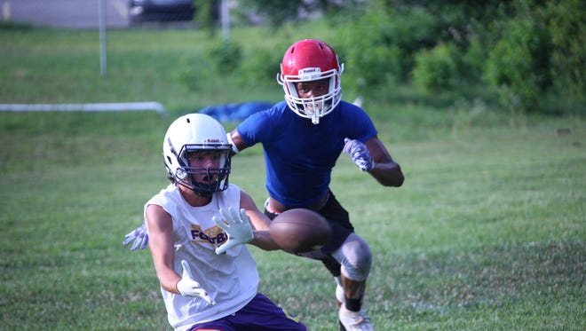 A Clarksville High player slides to catch a pass during a practice session that included  Montgomery Central Tuesday night at CHS.