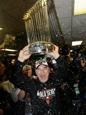 FILE - In this Oct. 29, 2014, file photo, San Francisco Giants manager Bruce Bochy celebrates after Game 7 of baseball's World Series against the Kansas City Royals, in Kansas City, Mo. Bochy says he will retire after this season, his 25th as a big league manager. Bochy says he told the team of his decision on Monday, Feb. 18, 2019. (AP Photo/David J. Phillip, File)