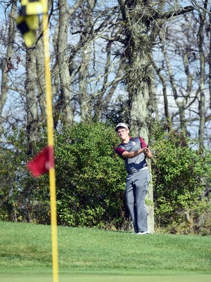 John Glenn's Jonah Hanes chips on to the 17th green during the opening round of the Division II state tournament on Friday at NorthStar Golf Club.