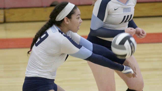 Mount Notre Dame's Sydney Mukes gets a dig during the the Cougars regional semifinal win over Lakota East.