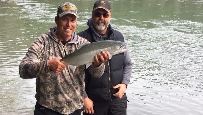 Guide Dave Jacobs, left, and Todd Simonis of Igo show a Smith River steelhead caught and released in the middle Smith River this past week