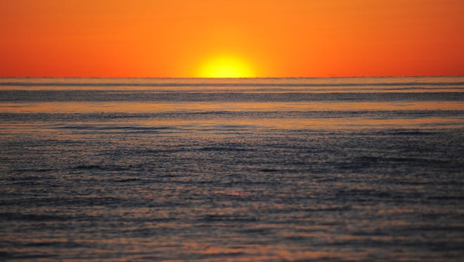 The sun sets over the Chesapeake Bay off the coast of Silver Beach, Va. on Sunday, April 3, 2016.