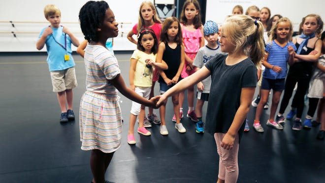 Kaili Holly, 8, (left) and Lucy Schill, 6, practice a scene during a musical theater camp at the Children's Theatre of Cincinnati new facility on Red Bank Road in Hyde Park.