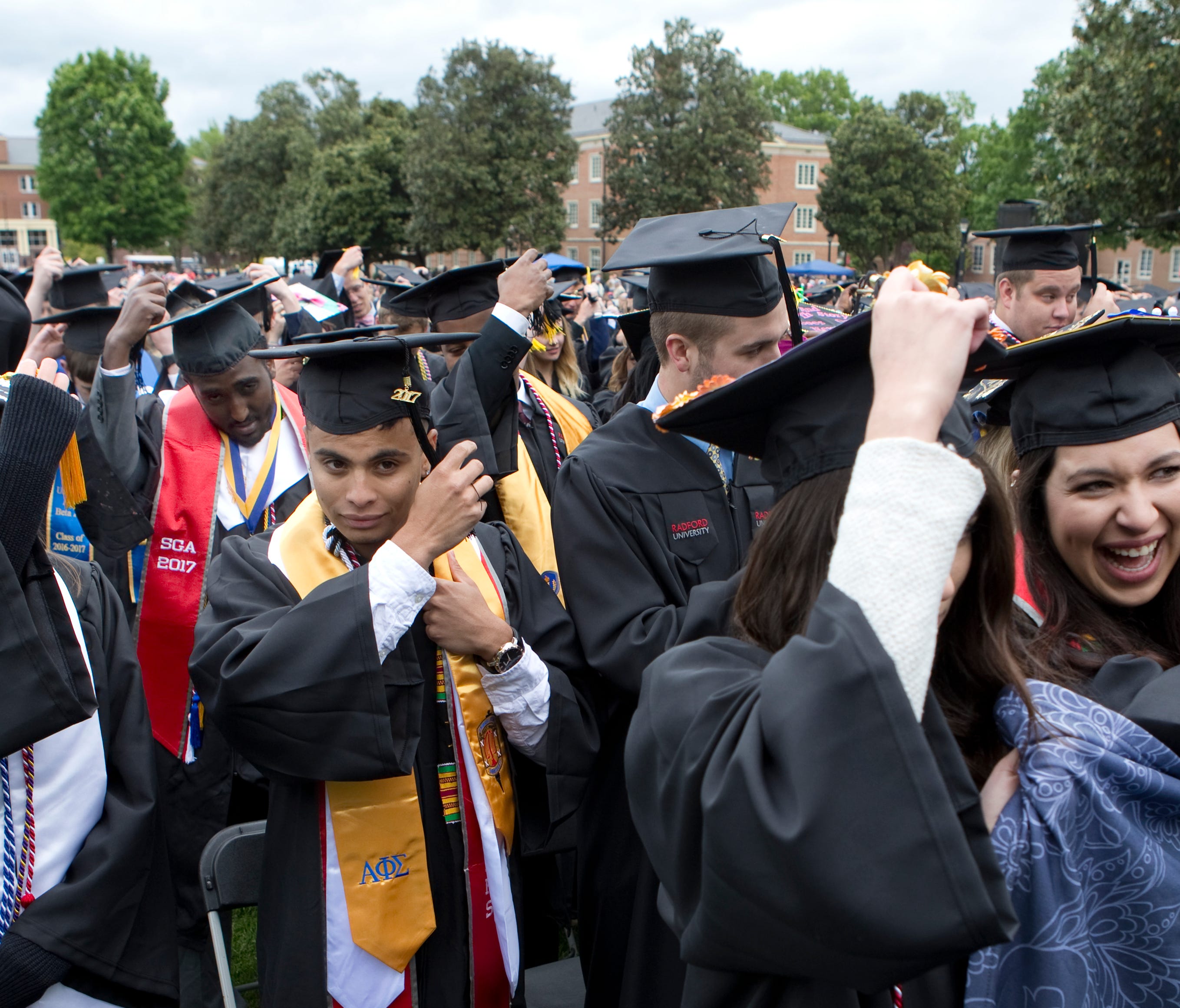 Graduates turn their tassels during the conferring of degrees portion of the commencement ceremony at Radford University May 6, 2017.