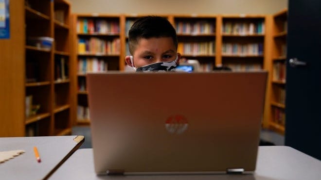 A Los Angeles Unified School District student attends an online class at the Boys and Girls Club of Hollywood on Wednesday, Aug. 26, 2020. The facility is open for children whose parents must leave home for work. There is no charge. Snacks and lunch are provided.