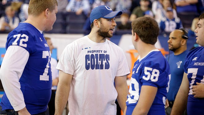 Indianapolis Colts quarterback Andrew Luck (12) talks with high school football players before the start of their game against the Houston Texans Sunday, Dec. 31, 2017. 