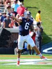 University of Virginia quarterback Kurt Benkert throws